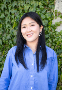 Jubilee Cho against a green plant background