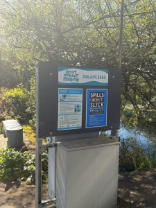 Informational signage posted outside the gate to Boat Street Marina's dock area for boaters to use.