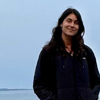 Dana Grant standing by the sea