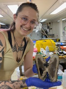 Mel Lemke holding a mollusc