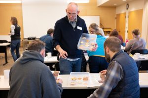 An instructor training volunteers on how to distinguish different types of crab molts.