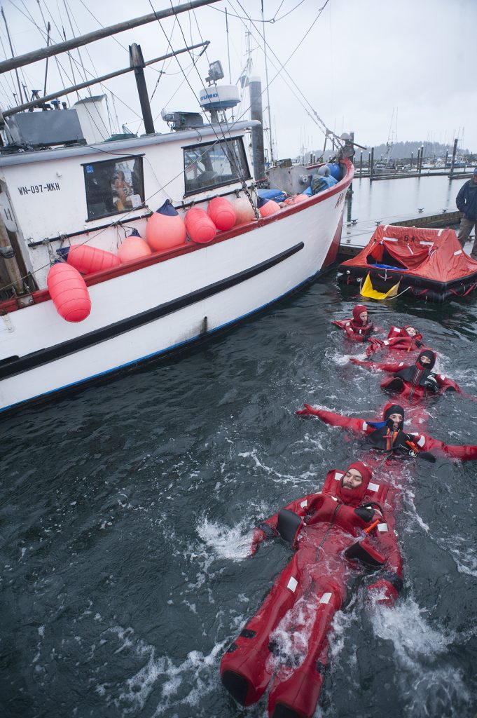 Makah Tribal fishermen swim toward a life raft during one of Fisken’s Safety at Sea workshops.