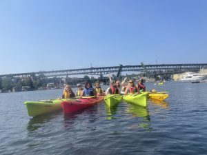 Fellows kayak at their orientation with fellowship and research specialist Deborah Purce (far right).