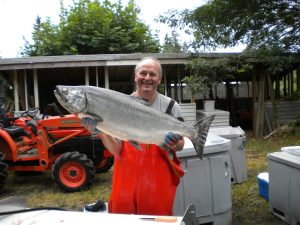Robert Sudar holds up a large salmon