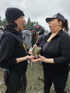 Dawn and a fellow Taylor Shellfish team member marveling at a live oyster.