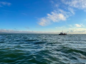 A fishing boat floats on ocean waves