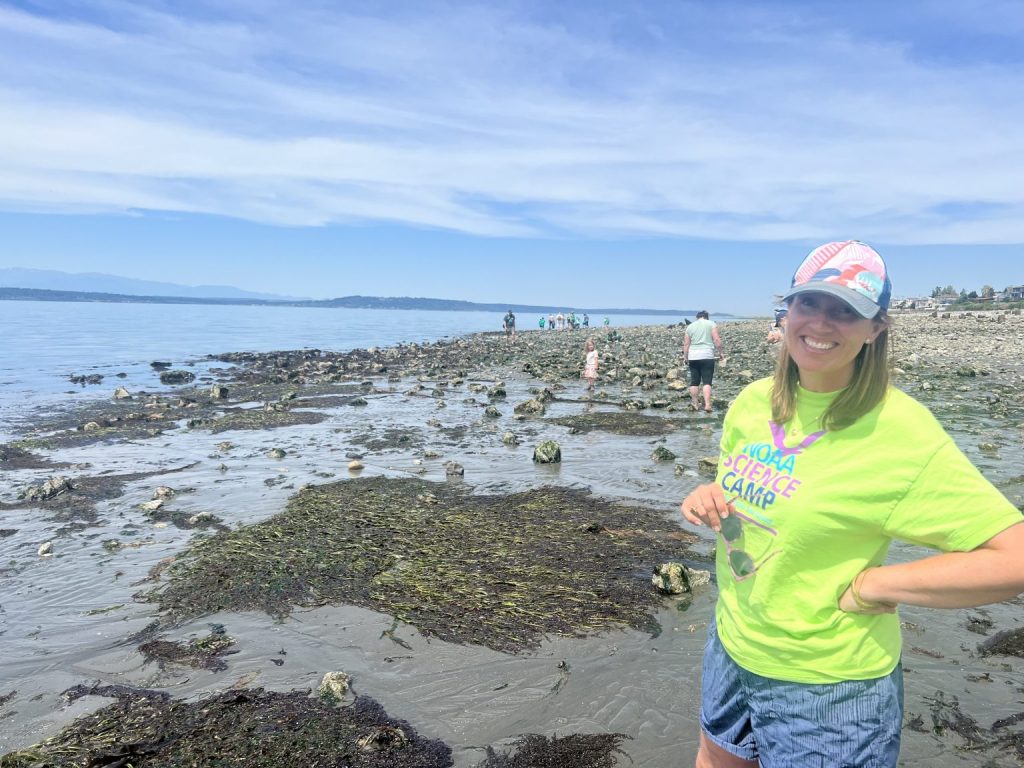 Maile Sullivan stands on a beach during a low tide public event.