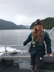 Olivia Horwedel on a boat with a fjord in the background