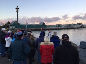 People gather at a waterfront king tides event