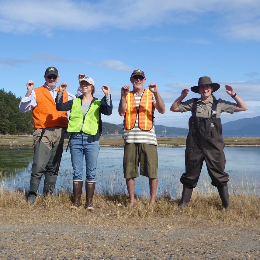 Crab team volunteers doing a silly pose on the beach
