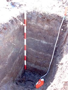 A pit into the earth in Discovery Bay, marked with a measuring stick