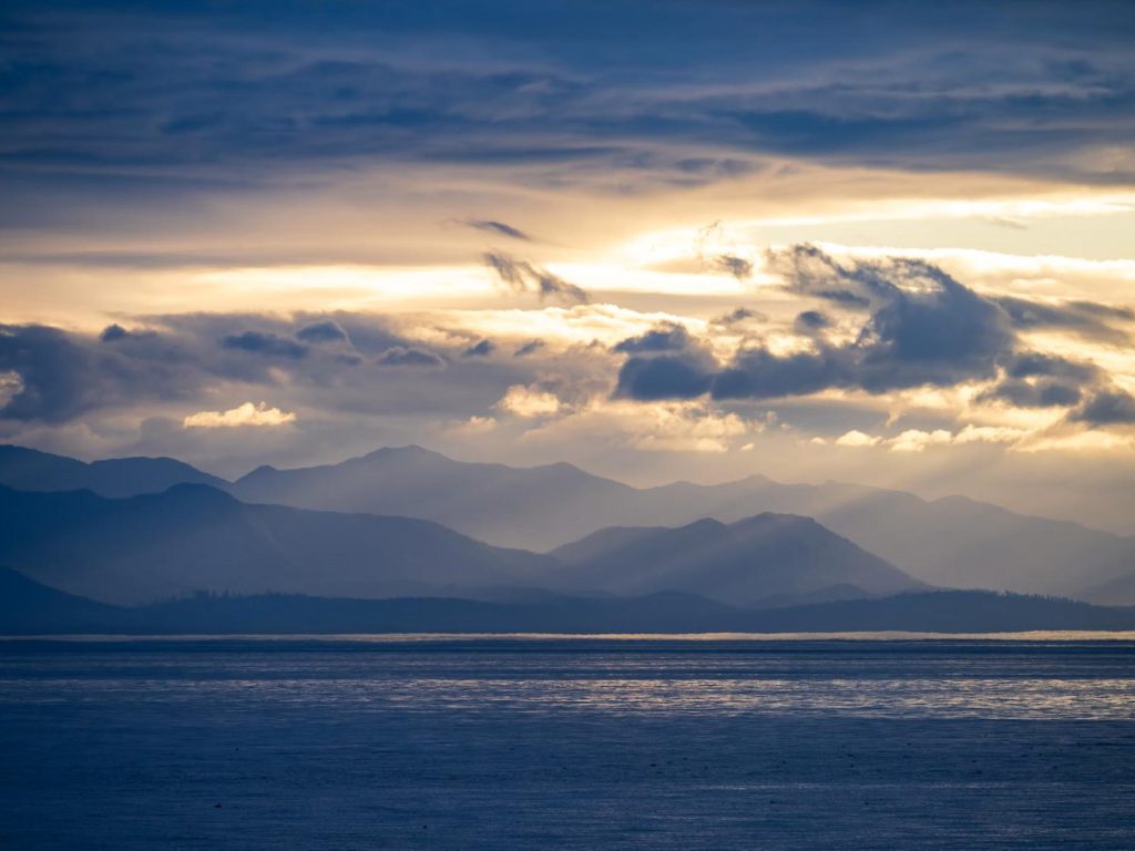 Mountains near the Straits of Juan de Fuca with a cloudy sunset sky