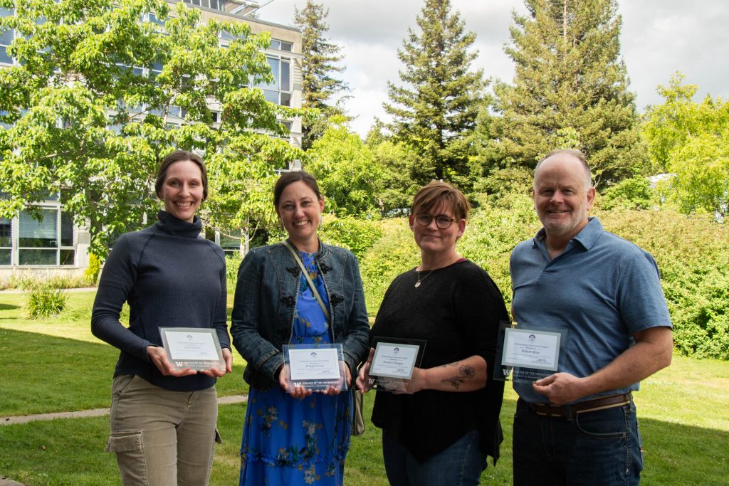 WSG Fisheries team, including Jenna Keeton, Bridget Trosin, Brandii O'Reagan, and Robert Maw, smile while holding awards.