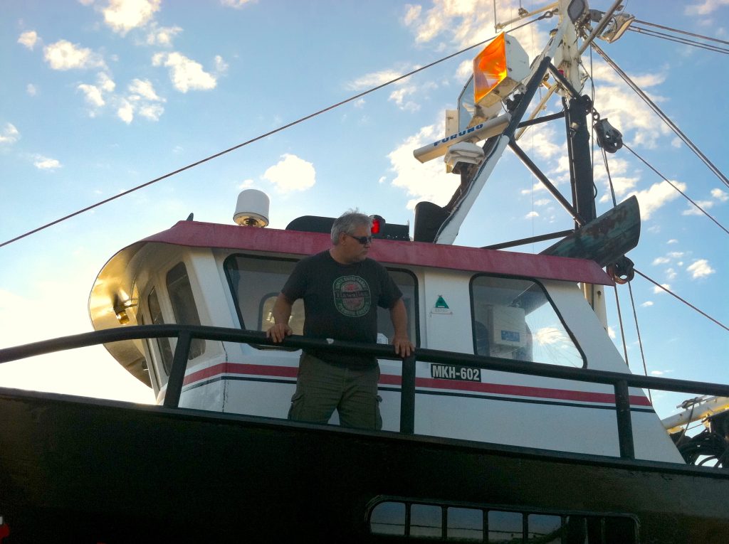 Dave Sones stands on the deck of his boat