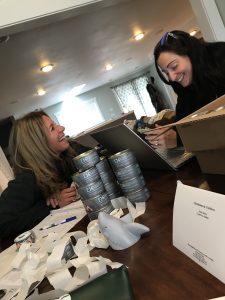 Libie and Teresa labeling cans of albacore