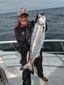 Marina holding a large Chinook salmon