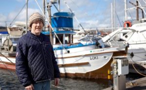 Pete Knutson in front of his boat