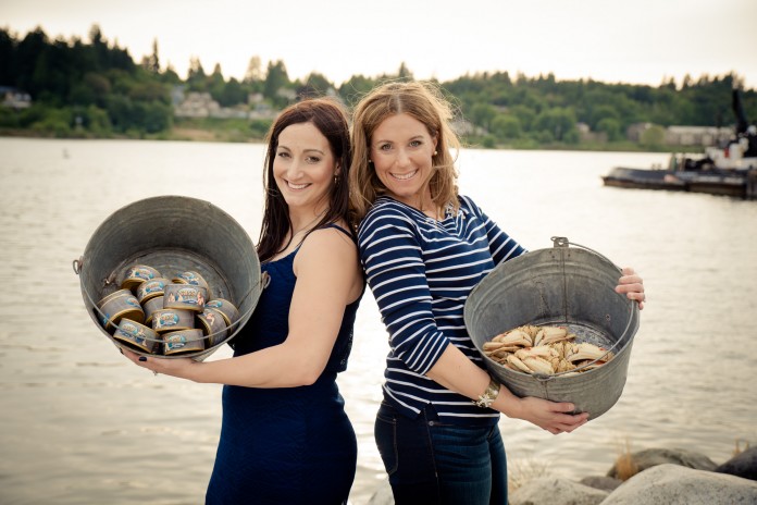 Teresa and Libie holding buckets of seafood