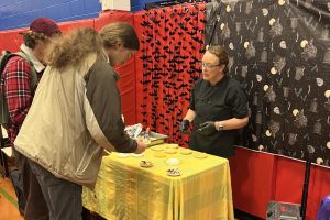 WSU Consultant Stacey Larsen serves two students lingcod tacos